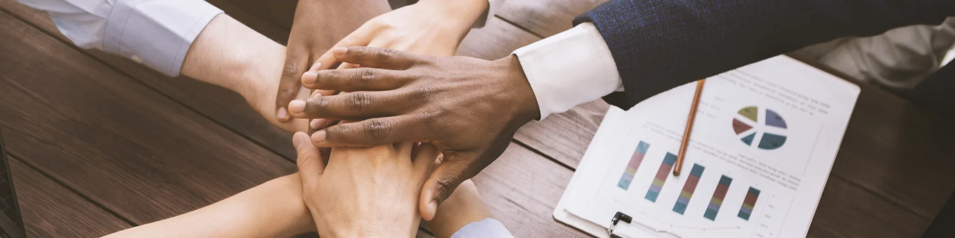 Business collaboration. Top view on diverse corporate team hands stacked together in office, top view