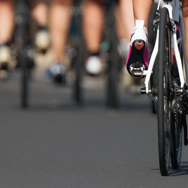 Cycling competition cyclist athletes riding a race at high speed